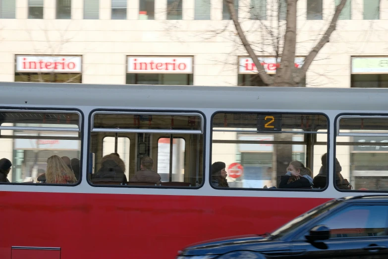 people are riding a city bus as it passes by