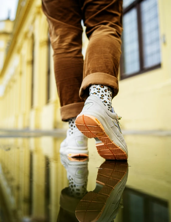 the back view of someones feet wearing sneakers