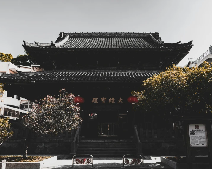 a chinese pagoda with stairs and trees lining the side