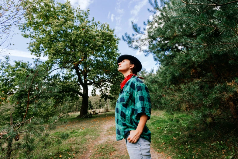 a man in a hat stands on a path
