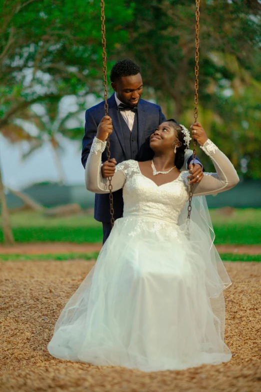 a man in a suit and tie is being married on a swing