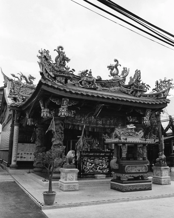 a group of statues near a building under a cloudy sky