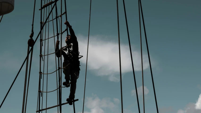 several people are working on the sails of a sail boat