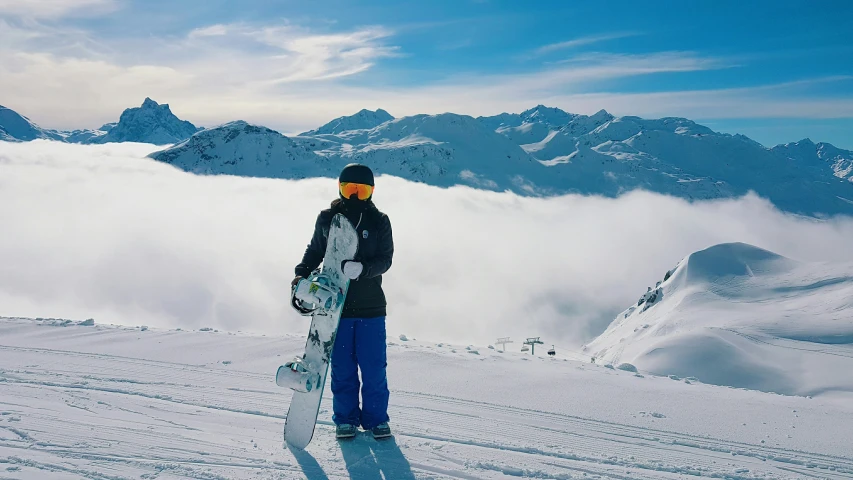 a person on skis standing on top of a snow covered hill