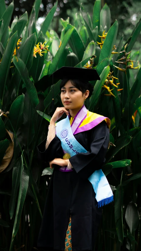 the graduate is dressed up in her regal gown