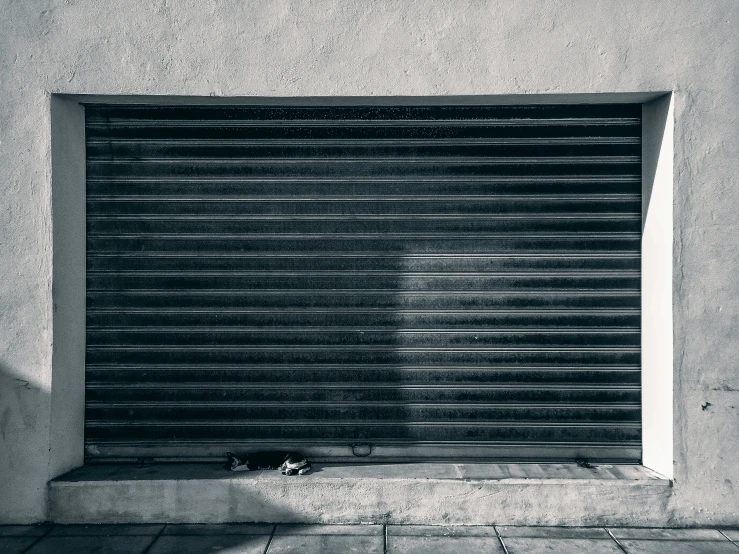 an empty street outside with a closed garage door