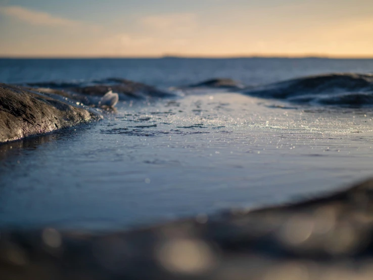 waves crash in the ocean on a sunny day