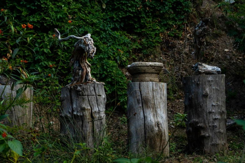 there are three large wooden posts with an owl on them