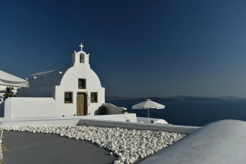 the church sits on the hill overlooking a body of water