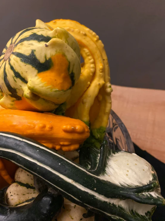 an assortment of gourds and squash are stacked together