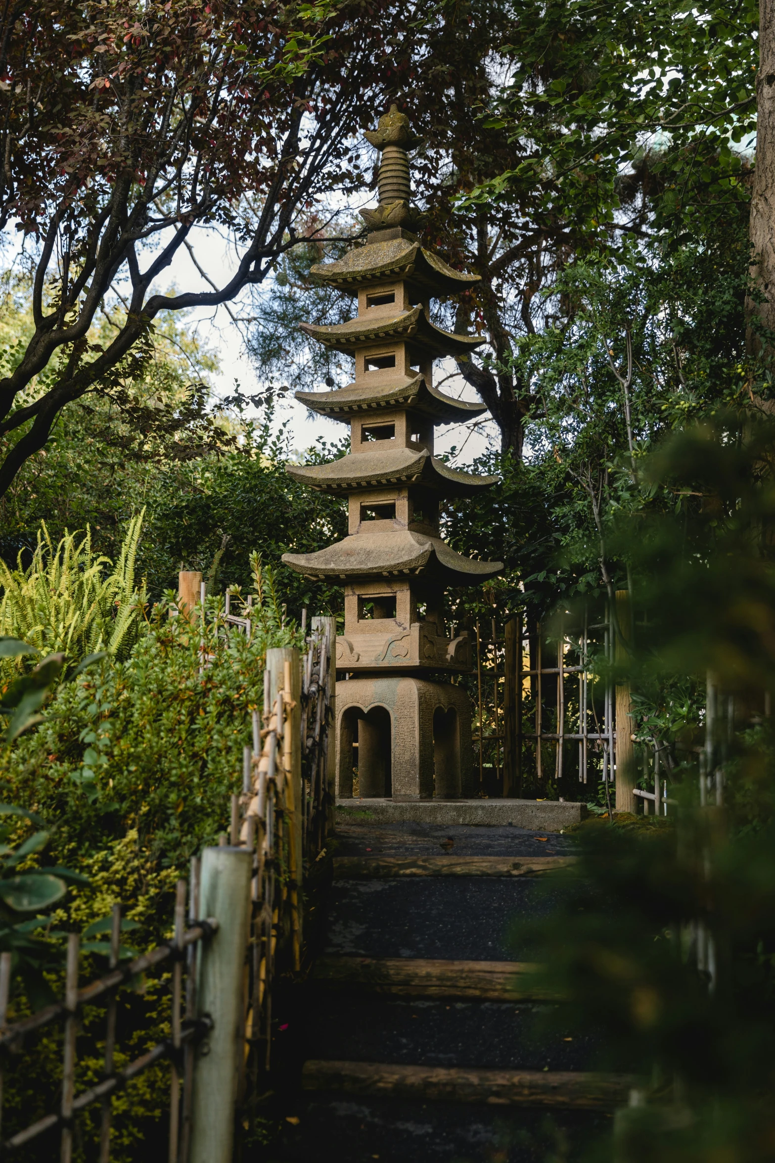 a tall tower is in the middle of the path