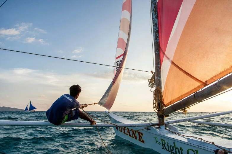 the man is in a boat that looks like an old sailboat