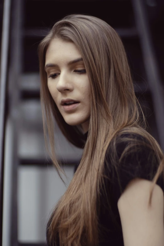 a woman with long hair is standing outside