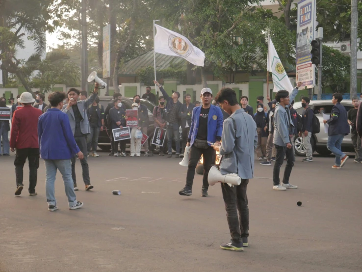 young men riding skate boards down a street