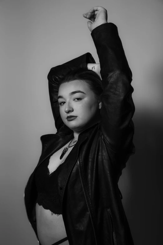 a woman with a leather jacket on posing for a picture