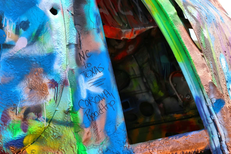 graffiti on an old car has the door open