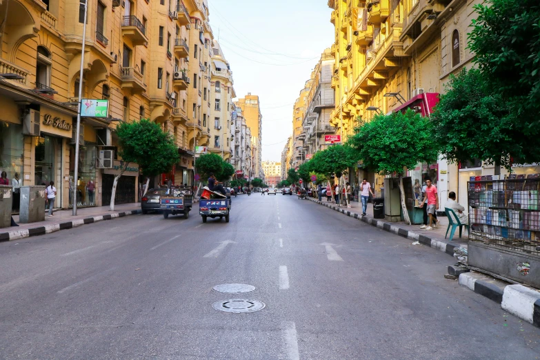 an empty street is shown with many shops