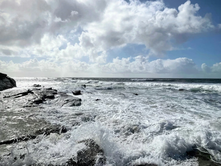 the waves were crashing on the rocks and water