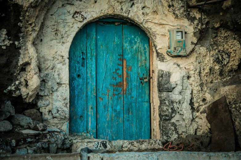 an old blue door in a stone building