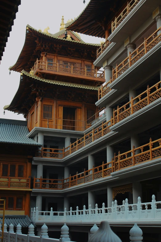 the outside view of an asian building with wood accents