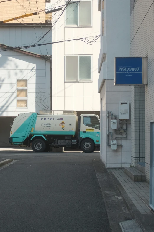 a garbage truck is parked on the side of the street