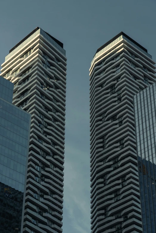 the two tall buildings are reflecting in each other's windows