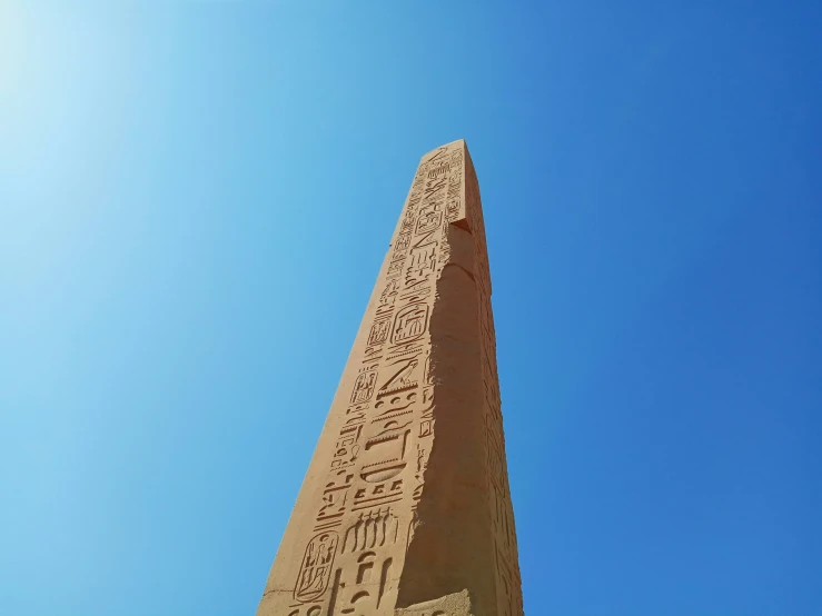 a big tall pillar with egyptian writing on it