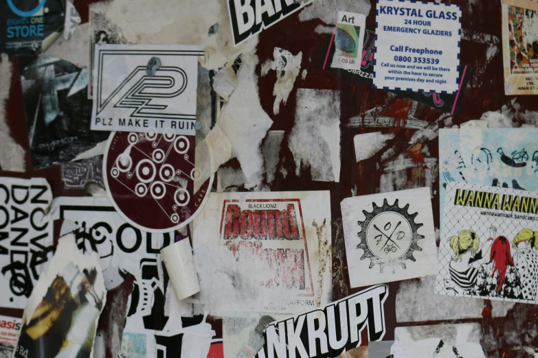 a bunch of stickers are seen on a wall