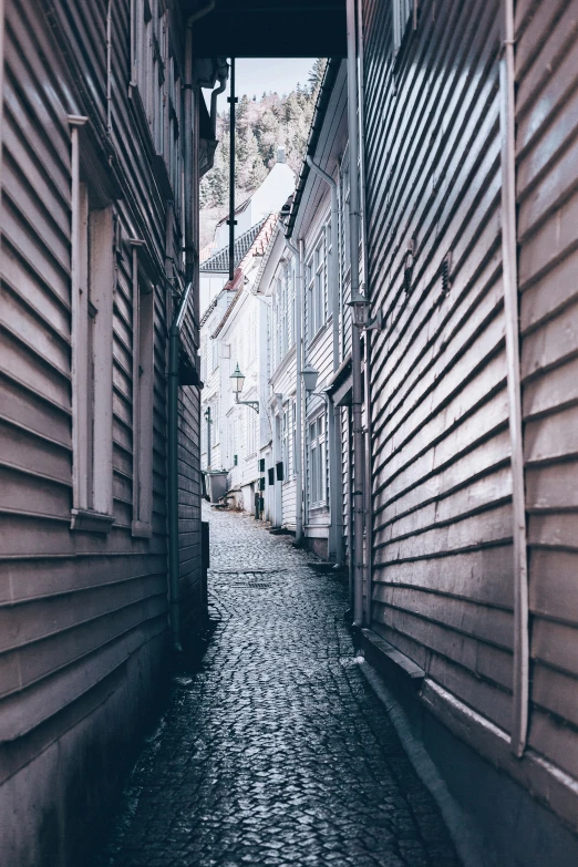 a narrow street with lots of buildings on both sides