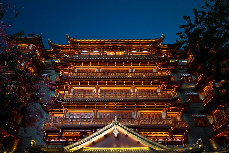 the very tall building has elaborate decoration at night