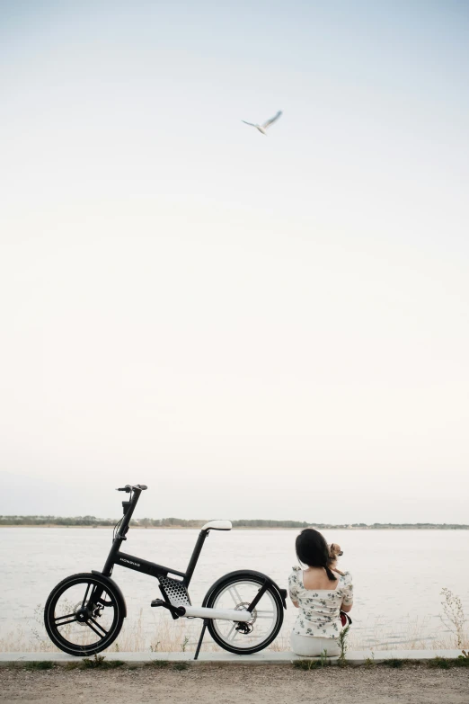 a bicycle parked next to the side of a body of water