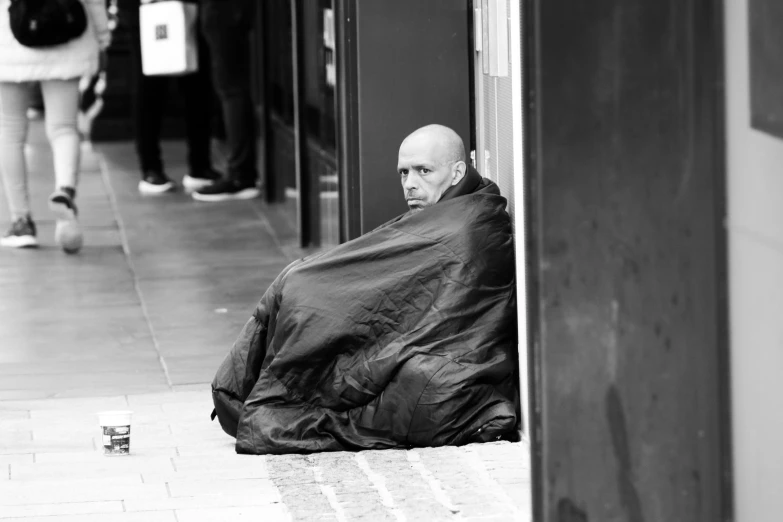 the balding man is looking at a woman on a sidewalk