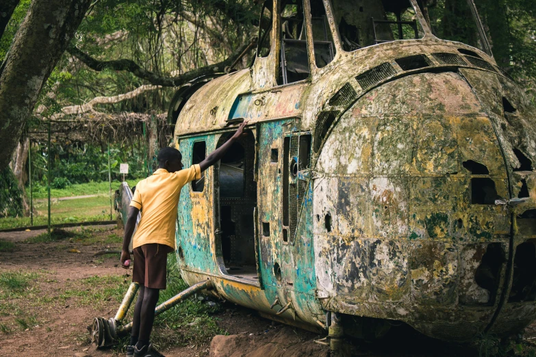 a person is washing a broken down vehicle