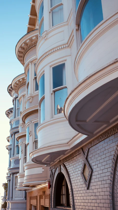 an elegant white building with blue windows is shown