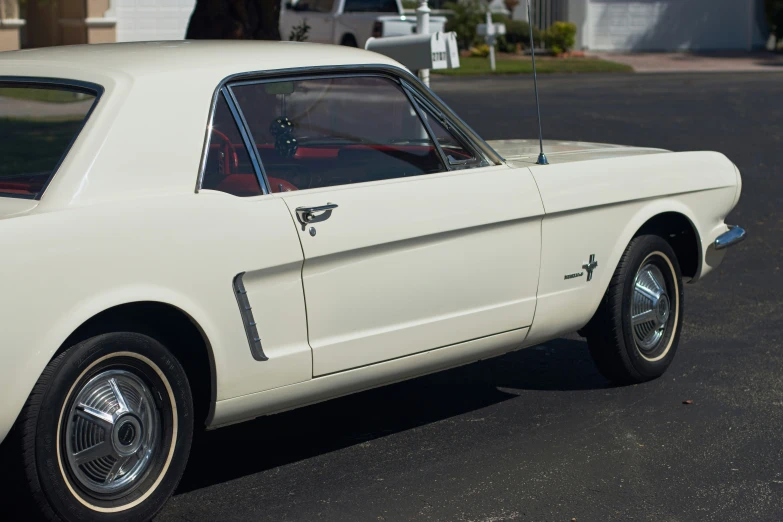 a white mustang sitting in a parking lot