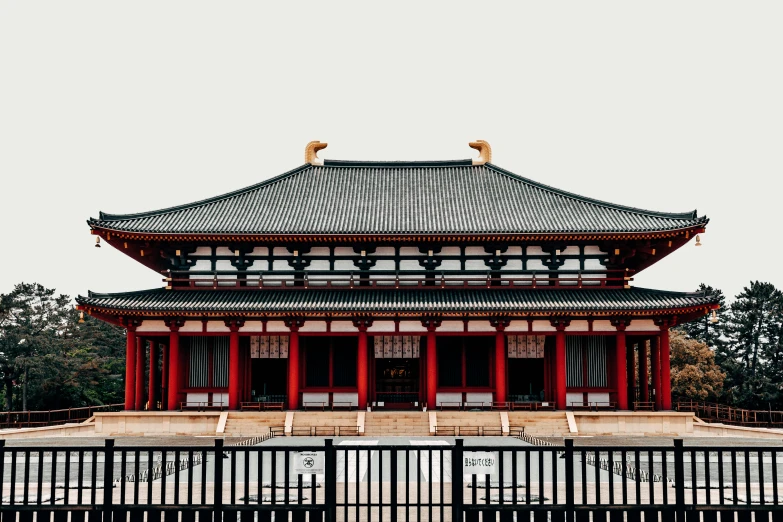 a building with a fence around it on a snowy day