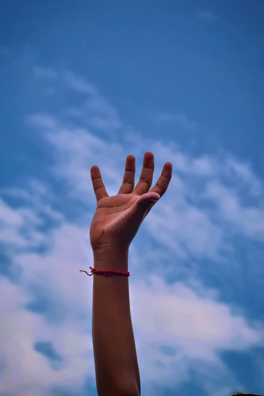 a person has their arm outstretched up into the sky