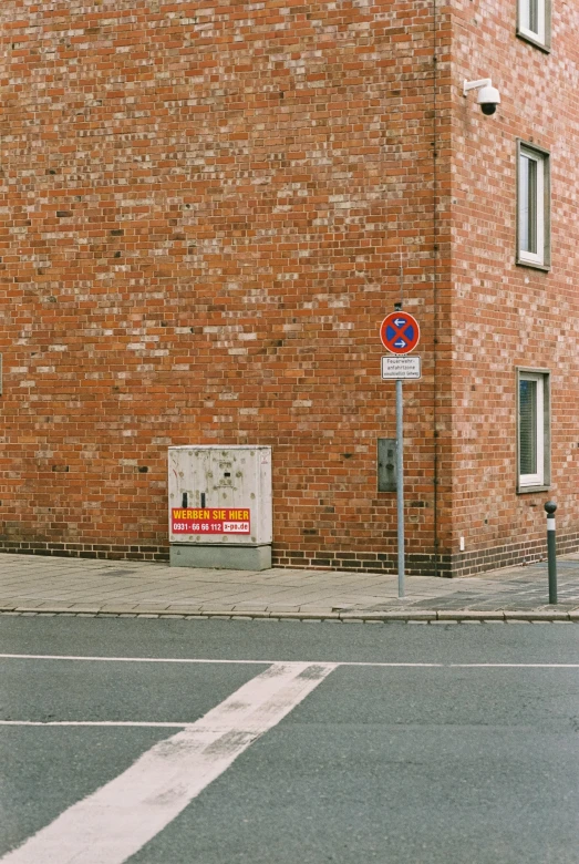 a brick building with no parking signs on the corner