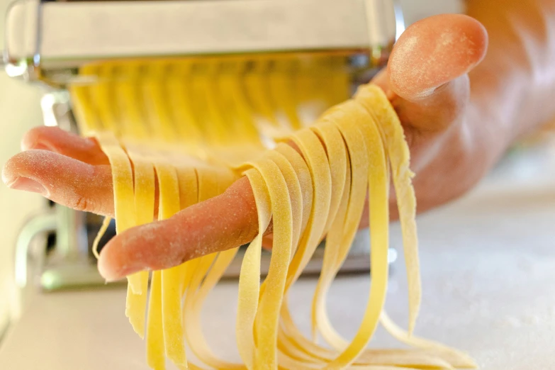 sausages, pasta and other vegetables are being prepared in an appliance