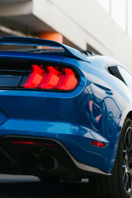 the rear end of a blue sports car