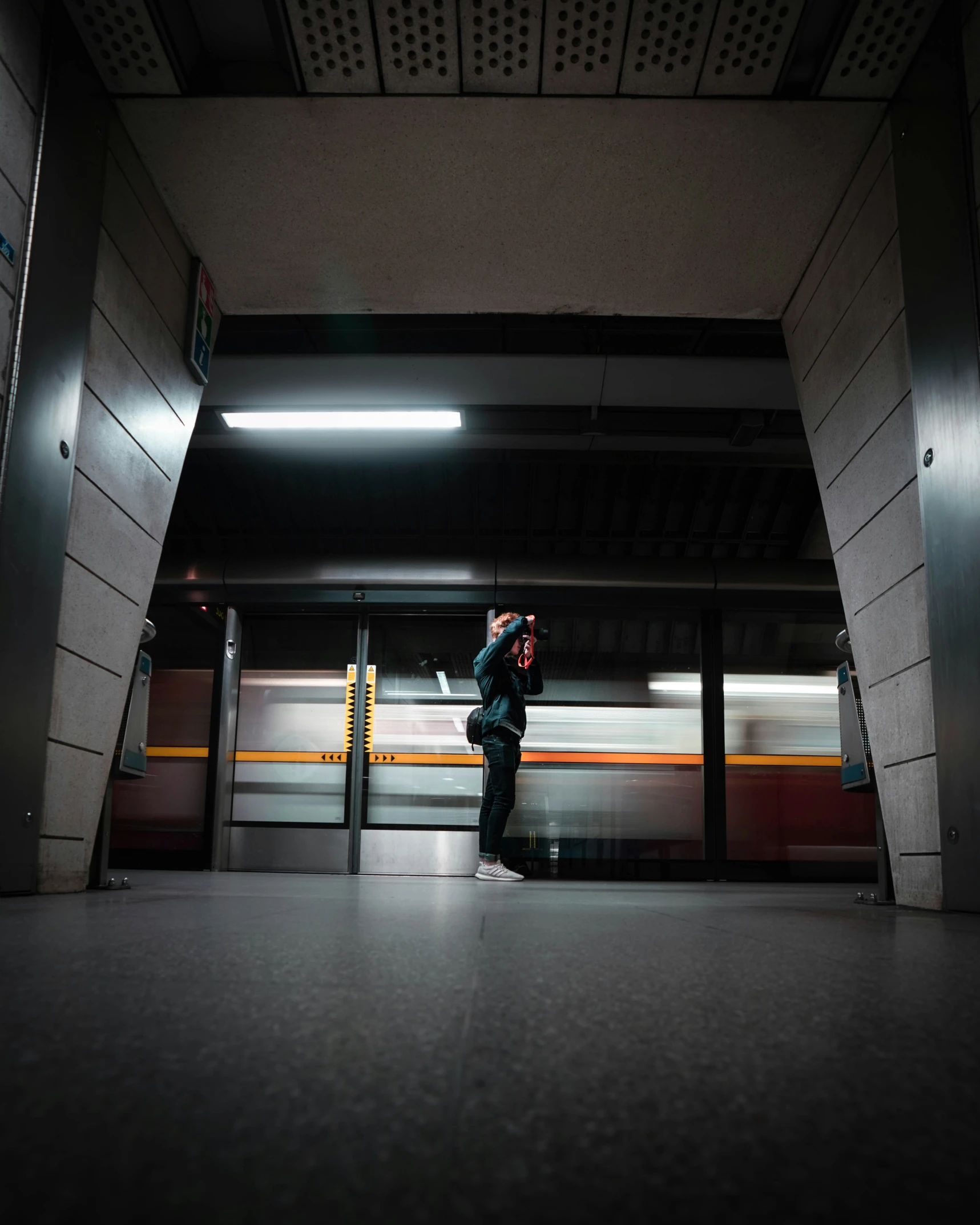 man taking his picture in a subway station