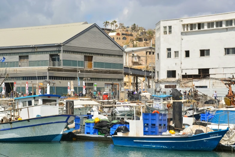 two boats tied up next to each other in a marina