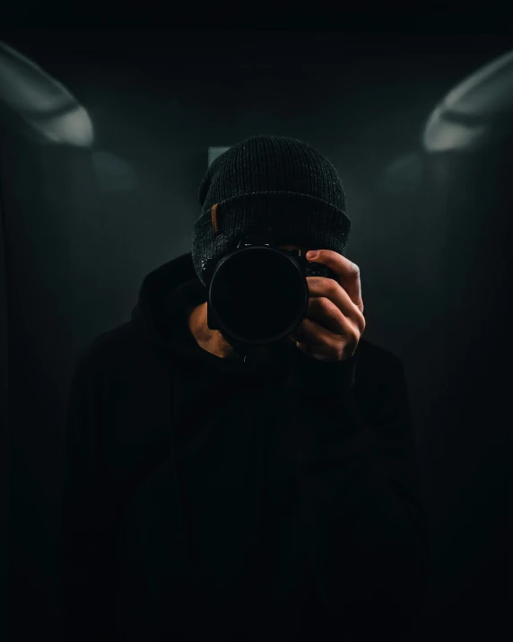 a man in the dark taking a po with his camera