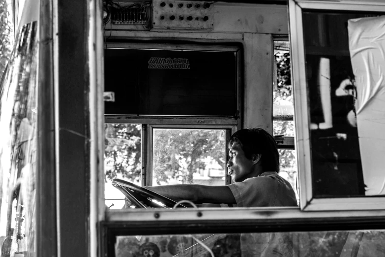 a woman in a bus looks out the window