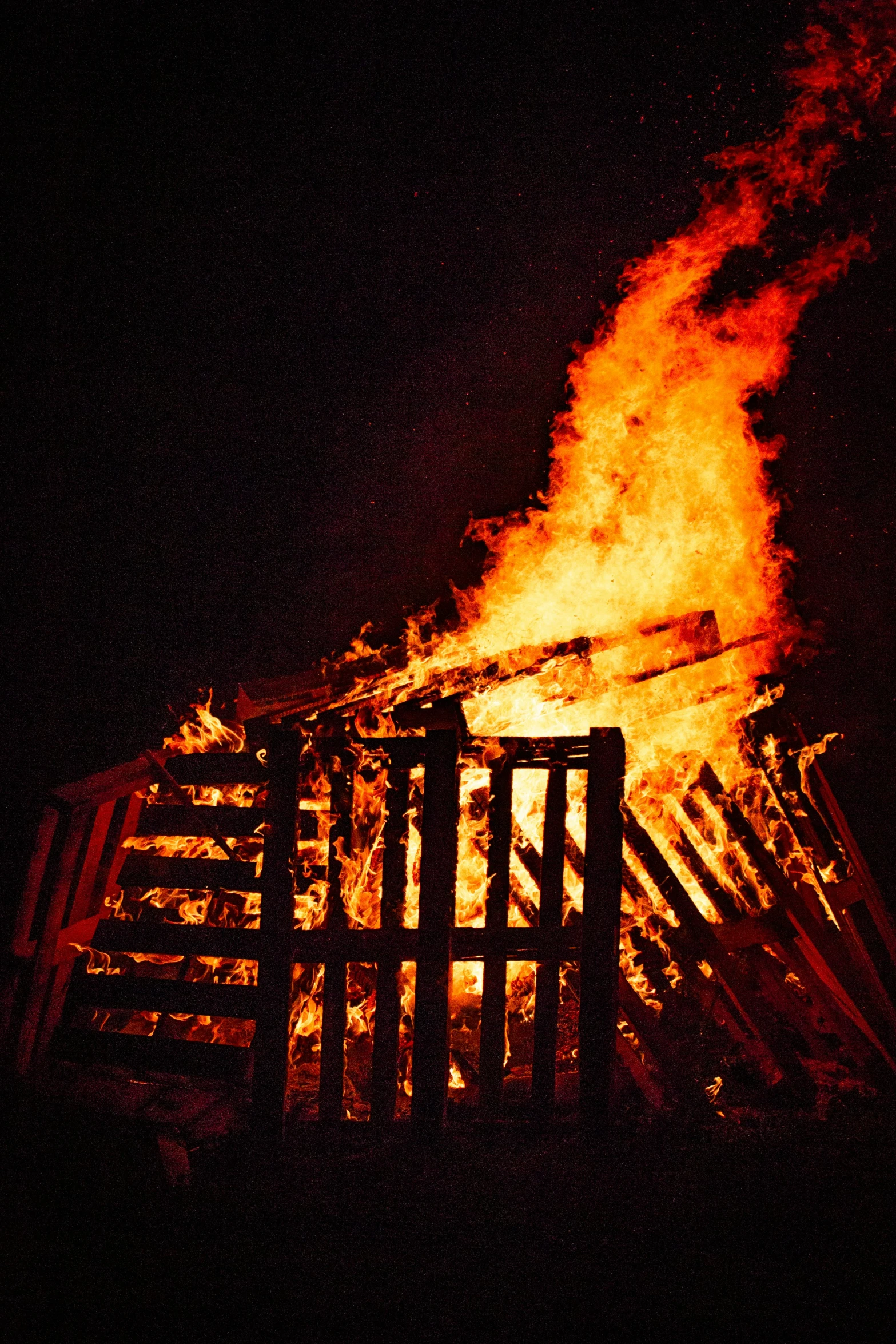 the dark background shows a building with bright flame