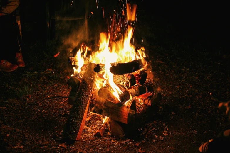 a large fire burning on a camping field