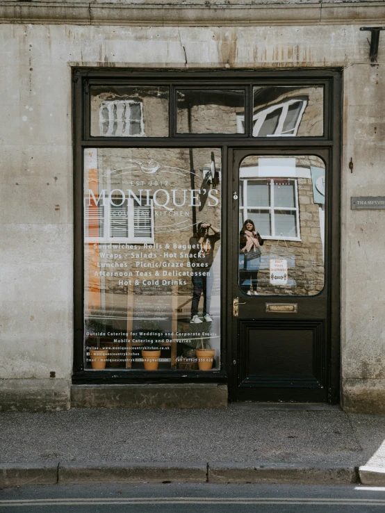 the store front of a store with signs on the windows