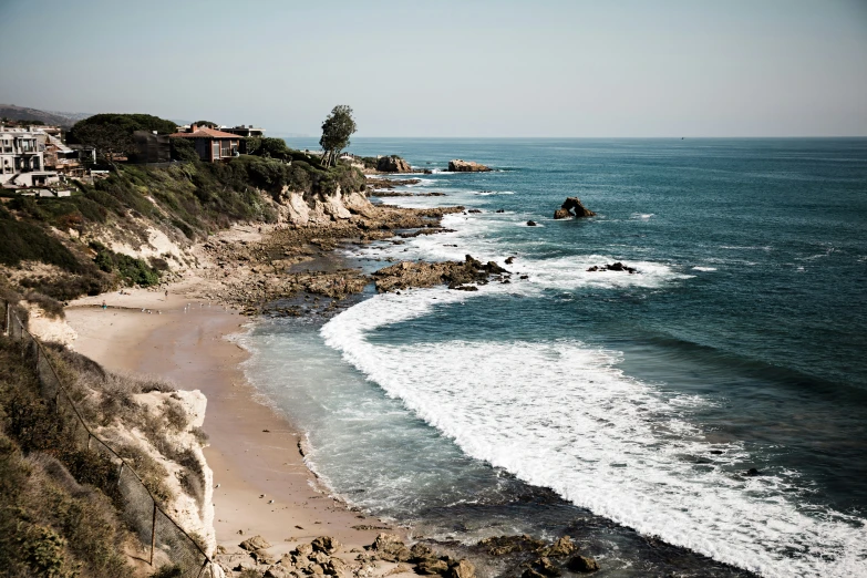 the view down the beach towards houses and the ocean