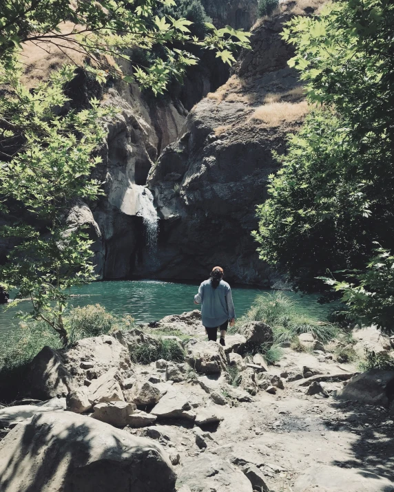 a man stands on the bank of a river