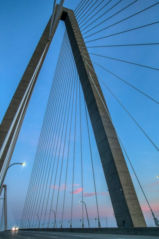 traffic passes under the modern bridge in a city